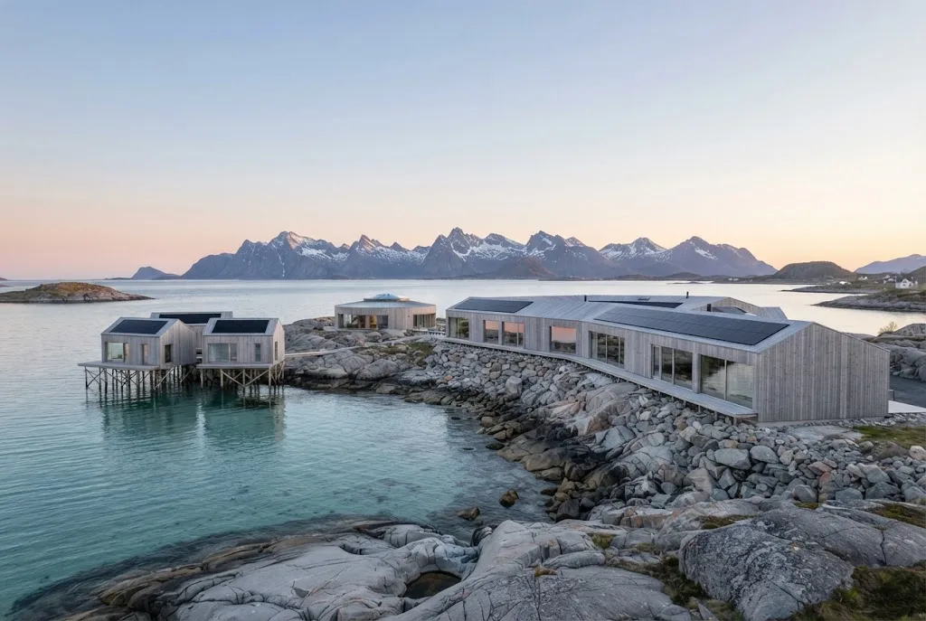 Artist's impression of the planned lodge seen at eye level from the rocky shore in soft light, with islands in the distance