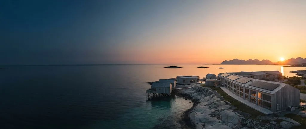 Artist's impression of the midnight sun over the sea, with the lodge in silhouette on the shore